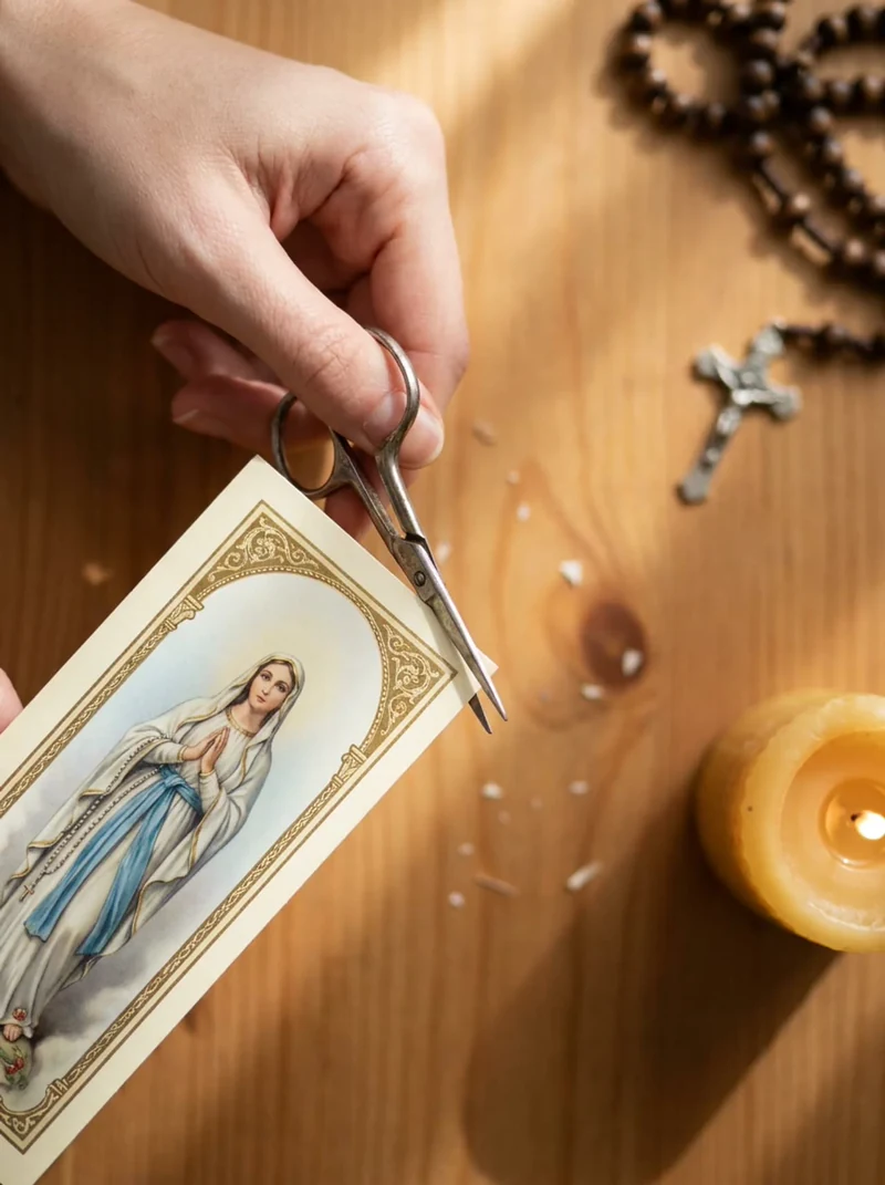 Cutting out a Marian bookmark with scissors